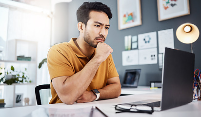 Image showing Computer, thinking and man in office with online research, website design planning and working in creative business. Focus, serious and designer or asian person on laptop, project decision and ideas