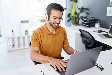 Image showing Laptop, headphones and business man listening to music, audio and working. Asian male entrepreneur at desk to listen to a song while typing for online research, email or social media with internet