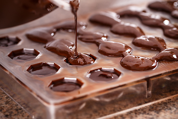 Image showing Putting chocolate in mold