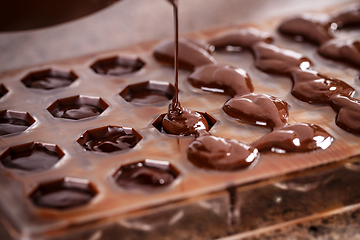 Image showing Putting chocolate in mold