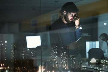 Image showing Business man, tablet and headache, pain or migraine in office by widow with city lights at night. Technology, fatigue or person with depression, brain fog or anxiety, stress or burnout with deadline.