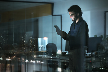 Image showing Business man, tablet and smile in office, online browsing or internet scroll by window with city lights at night. Technology, happiness and professional person with touchscreen for research deadline.