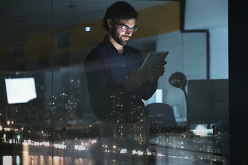 Image showing Business man, tablet and research in office, online browsing or internet scrolling by window with city lights at night. Technology, happiness and professional person with touchscreen for deadline.