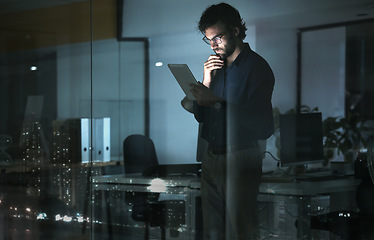 Image showing Business man, tablet and thinking in office, problem solving or looking for solution by window with city lights at night. Technology, idea and professional person with touchscreen to focus on reading