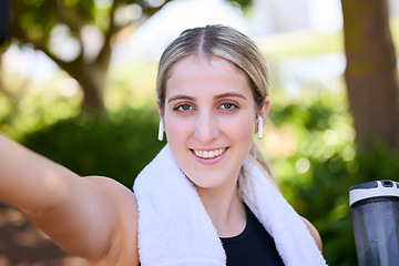 Image showing Portrait, happy woman or fitness influencer taking a selfie at training, running or workout in a park. Smile, runner or healthy girl athlete in headphones talking pictures or photo on social media