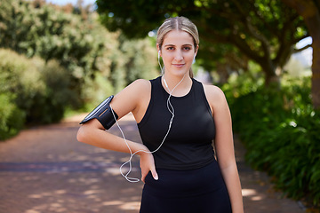 Image showing Headphones, runner or portrait of woman in park training, exercise or workout for a healthy body. Wellness, fitness break or sports girl athlete exercising or streaming audio or radio song in nature