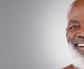 Image showing Senior black man, face and smile on mockup for skincare, hygiene or grooming against a gray studio background. Portrait of happy African elderly male smiling for self love or skin care on copy space