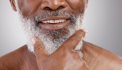 Image showing Beauty, hand and beard with a senior man in studio on a gray background for skincare or grooming. Mouth, smile and facial hair with a happy mature male closeup for a luxury cosmetic facial product