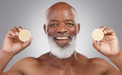 Image showing Senior black man, portrait and fruit for vitamin C, skincare or natural nutrition against gray studio background. Happy African American male smile and citrus lemon for healthy skin, diet or wellness