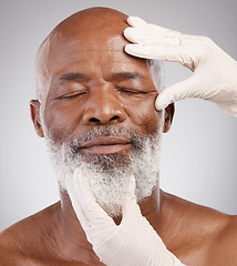 Image showing Skincare, hands or gloves for black man in cosmetic treatment, professional anti ageing or white background. Dermatology, face and mature male model at salon or clinic for medical skin care in studio