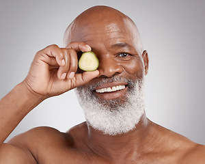 Image showing Senior black man, portrait smile and cucumber for natural skincare, nutrition or health against a gray studio background. Happy African American male with vegetable for healthy skin, diet or wellness