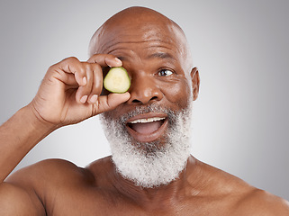 Image showing Senior black man, smile and cucumber for skincare, natural nutrition or health against a gray studio background. Happy African American male with vegetable citrus for healthy skin, diet or wellness