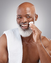 Image showing Dermatology, cotton pad and portrait of black man with smile, happiness and anti ageing treatment in studio backdrop. Skin care, cosmetic and happy, mature model with morning skincare or face routine