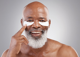 Image showing Collagen eye mask, skincare or portrait of black man and smile, happiness or face treatment on white background Dermatology, cosmetic facial and happy, mature or model and eyes pad on studio backdrop