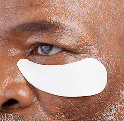 Image showing Skin care, eye mask and zoom on black man with professional anti ageing spa treatment with collagen. Dermatology, cosmetic process and face of mature model with patch on eyes for skincare routine.