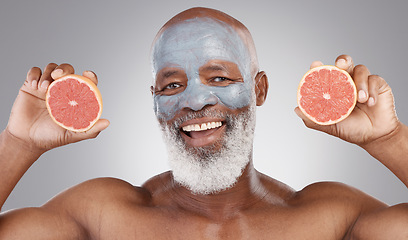 Image showing Senior black man, grapefruit and portrait in skincare, vitamin C or natural nutrition against a gray studio background. Happy African male smile with fruit and face mask for healthy skin or wellness
