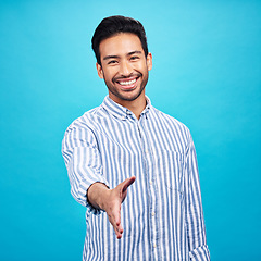 Image showing Handshake, interview and portrait of business man on blue background for thank you, welcome and deal. Recruitment, hiring and male shaking hands for opportunity, agreement and onboarding in studio