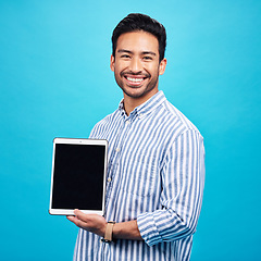 Image showing Man, tablet and mockup screen, smile in portrait and digital device marketing with tech on blue background. Wireless touchscreen, website or internet branding, advertising and happy male in studio