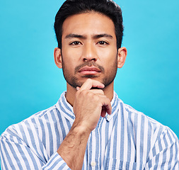 Image showing Portrait of man on blue background, thinking and serious expression and hand on face isolated on studio backdrop. Confidence, mockup space and professional male model with pride and vision for future