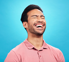 Image showing Laughing, funny comedy and man in studio isolated on a blue background. Comic, humor and male person laugh at joke, laughter and happiness, cheerful and carefree for hilarious smile, excited or emoji