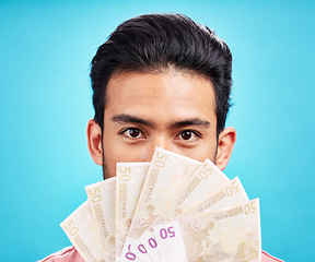 Image showing Man in portrait, money fan and cash with finance, prize or reward isolated on blue background. Financial savings, bonus or competition win with payment, male person with economic success in studio