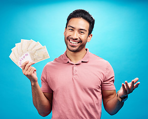 Image showing Happy man in portrait, cash fan and financial freedom with money, prize or reward isolated on blue background. Finance with savings, bonus and male person with smile and economic success in studio