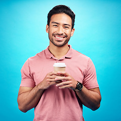 Image showing Portrait, smile and Asian man with coffee, start motivation and confident guy against a blue studio background. Face, male person and happy model with cappuccino, tea and happiness with wellness