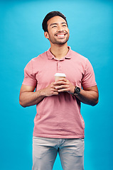 Image showing Thinking, smile and Asian man with coffee, ideas and decision against blue studio background. Thoughts, male person or happy model with cappuccino, tea or wonder with choice, happiness or opportunity