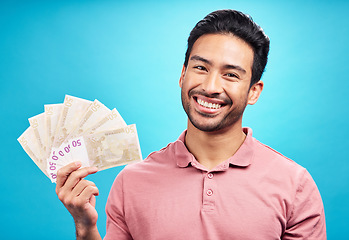 Image showing Happy man in portrait, money fan and cash prize with financial freedom and reward isolated on blue background. Finance, savings and investment payment, male person with economic success in studio