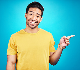 Image showing Man is pointing, advertising and promo with happiness and branding isolated on blue background. Opportunity, deal or announcement, marketing news and promotion ad with happy male person in portrait