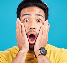 Image showing Surprised, wow and portrait of shocked man face or emoji reaction to an announcement isolated in a blue studio background. OMG, fake news and male model with amazed facial expression in backdrop