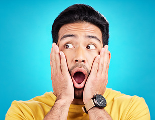 Image showing Surprised, announcement and shocked face of a man or emoji reaction to a deal isolated in a blue studio background. OMG, fake news and male model with amazed facial expression in backdrop