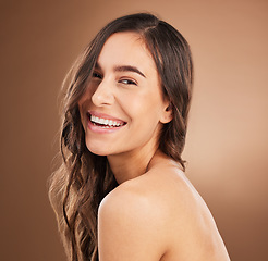 Image showing Portrait, hair and happy woman in studio for beauty, treatment and cosmetics on brown background. Haircare, face and girl smile for natural, curly or wavy, texture or keratin, shine and confidence
