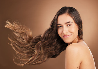 Image showing Hair, beauty and portrait of woman in studio for wellness, hairstyle treatment and health on brown background. Salon aesthetic, smile and face of happy girl with cosmetics, keratin and natural style