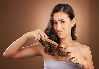 Image showing Hair care, damage and portrait of sad woman with comb, studio background and problem in salon treatment. Haircare crisis, mockup and frustrated latino model with split ends, dry or damaged hairstyle.