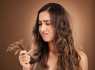 Image showing Beauty, crisis and sad woman in studio with hair loss, dry and damage against brown background. Haircare, fail and girl model frustrated with weak, split ends or alopecia while posing isolated