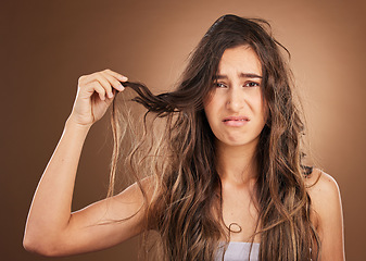 Image showing Hair loss, problem and portrait woman in studio for beauty, messy and damage against brown background. Haircare, fail and face of sad girl frustrated with weak, split ends or tangle posing isolated