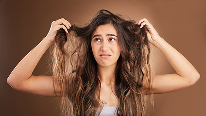 Image showing Problem, hair loss and sad woman in studio for beauty, messy and damage against brown background. Haircare, fail and unhappy girl frustrated with weak, split ends or alopecia while posing isolated