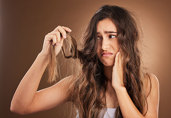 Image showing Hair loss, crisis and worried woman in studio for beauty, messy and damage against brown background. Haircare, fail and sad girl frustrated with weak, split ends or alopecia, dandruff and isolated