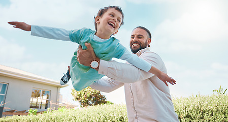 Image showing Airplane game, family and father playing with child or kid outside the home or house lawn backyard together. Smile, happy and dad or single parent carrying son flying and bonding with freedom