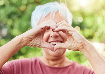 Image showing Portrait, hands and heart with a senior woman outdoor in a garden during summer for love or health. Face, emoji and shape with a hand gesture by a happy mature female outside in a park for wellness