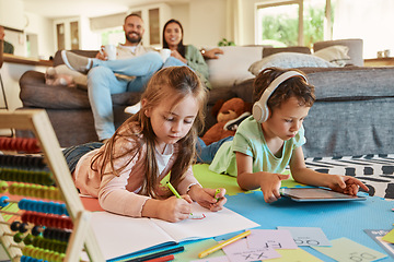 Image showing Learning, floor and children with family relax on sofa for home writing, creative development and tablet. Kids on carpet on digital games, headphones and online education with happy parents on couch