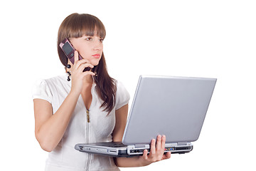 Image showing Businesswoman with laptop speaks on the cell phone