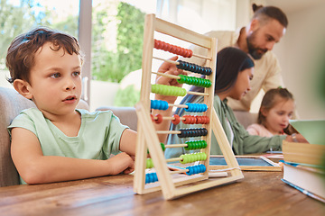 Image showing Education, mathematics and a boy counting on an abacus while learning in the living room of his home. Children, homework and study with a male school kid in his house for growth or child development