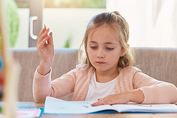 Image showing Homework, education and girl with focus, notebook and thinking in living room, studying and learning. Female child, person and student with knowledge, development and ideas for activity and writing