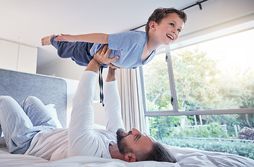 Image showing Happy, airplane play and dad with child and happiness in a bedroom with trust and love. Happiness, father and young kid together in the air from flying game feeling excited with papa lift at home