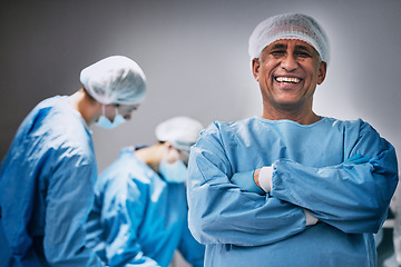 Image showing Theatre, portrait and man doctor with arms crossed for hospital teamwork, leadership and medical surgery. Happy surgeon or healthcare person in operating room or theater for emergency and solution