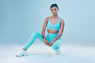 Image showing Fitness, portrait and focus with a sports woman in studio on a blue background for health or wellness. Exercise, mindset and serious with a female athlete training for a healthy body or lifestyle