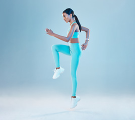 Image showing Fitness, focus and mockup with a woman runner in studio on gray background for health or wellness. Exercise, mindset and space with a young female athlete running or training for cardio or endurance