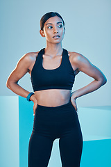 Image showing Thinking, fitness and woman with confidence, sports and training for balance, healthy lifestyle and goals on a blue studio background. Female person, girl and athlete with power, serious and workout